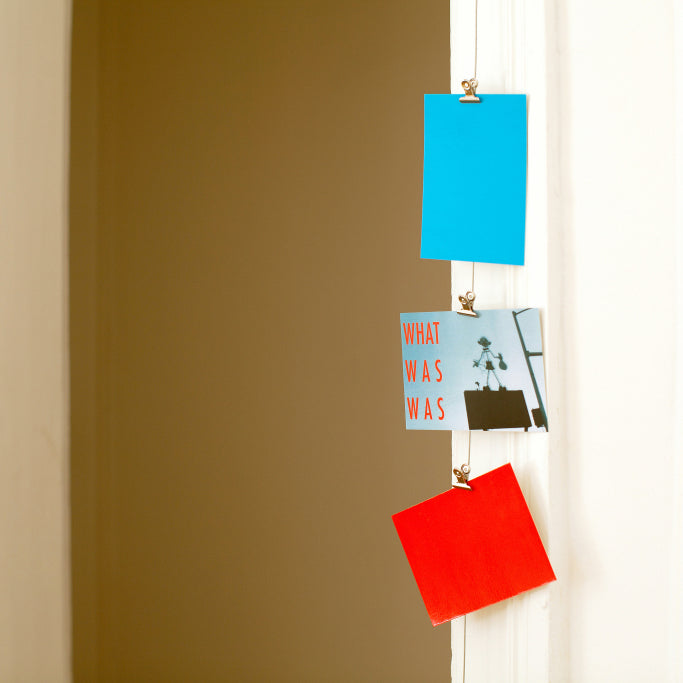 Fotokoord uit staal met magnetische clips opgehangen met kaartjjes eraan